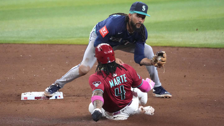 Jun 10, 2025; Phoenix, Arizona, USA; Seattle Mariners shortstop J.P. Crawford (3) forces out Arizona Diamondbacks second base Ketel Marte (4) at second base during the fifth inning at Chase Field. Mandatory Credit: Joe Camporeale-Imagn Images