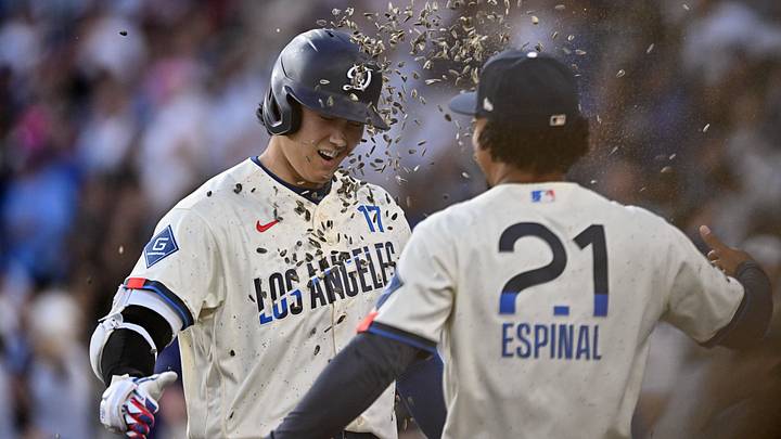 Jun 6, 2026; Los Angeles, California, USA; Los Angeles Dodgers designated hitter Shohei Ohtani (17) celebrates with infielder Santiago Espinal (21) after hitting a two run home run against the Los Angeles Angels during the first inning at Dodger Stadium. Mandatory Credit: William Liang-Imagn Images