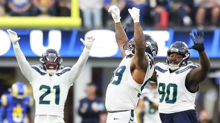 Jan 5, 2025; Inglewood, California, USA;  Seattle Seahawks Defensive End Leonard Williams (99), Free Safety Devon Witherspoon (21) and Nose Tackle Jarred Reed (90) celebrate a 4th down stop at SoFi Stadium, as the Seattle Seahawks face off versus the Los Angeles Rams Week 18 matchup. Mandatory Credit: William Navarro-Imagn Images