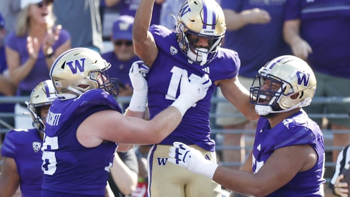 Geirean Hatchet, left, is back to reclaim a UW starting job. He's shown here with Jalen McMillan and Troy Fautanu in 2023.
