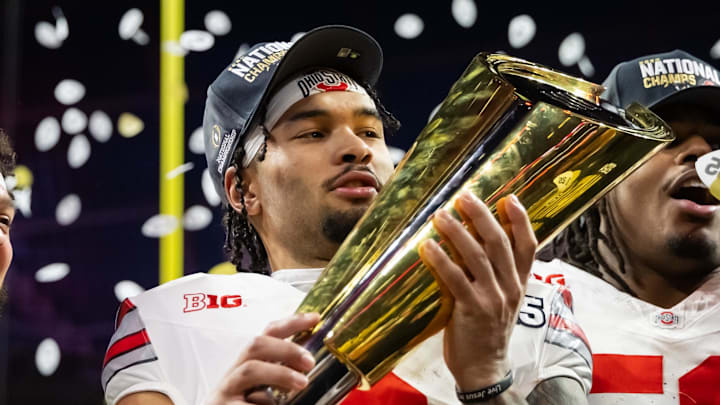 Jan 20, 2025; Atlanta, GA, USA; Ohio State Buckeyes wide receiver Emeka Egbuka (2) celebrates with the trophy after defeating the Notre Dame Fighting Irish during the CFP National Championship college football game at Mercedes-Benz Stadium. Mandatory Credit: Mark J. Rebilas-Imagn Images