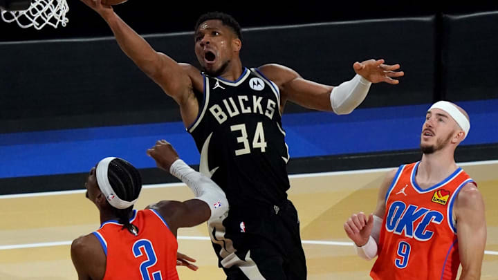 Dec 17, 2024; Las Vegas, Nevada, USA; Milwaukee Bucks forward Giannis Antetokounmpo (34) shoots against Oklahoma City Thunder guard Shai Gilgeous-Alexander (2) and guard Alex Caruso (9) during the 4th quarter of the Emirates NBA Cup championship game at T-Mobile Arena. Mandatory Credit: Kyle Terada-Imagn Images