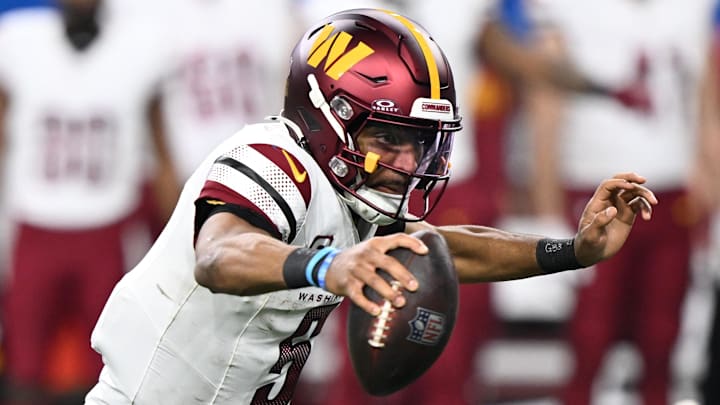 Jan 18, 2025; Detroit, Michigan, USA; Washington Commanders quarterback Jayden Daniels (5) scrambles out of the pocket during the fourth quarter against Detroit Lions in a 2025 NFC divisional round game at Ford Field. Mandatory Credit: Lon Horwedel-Imagn Images