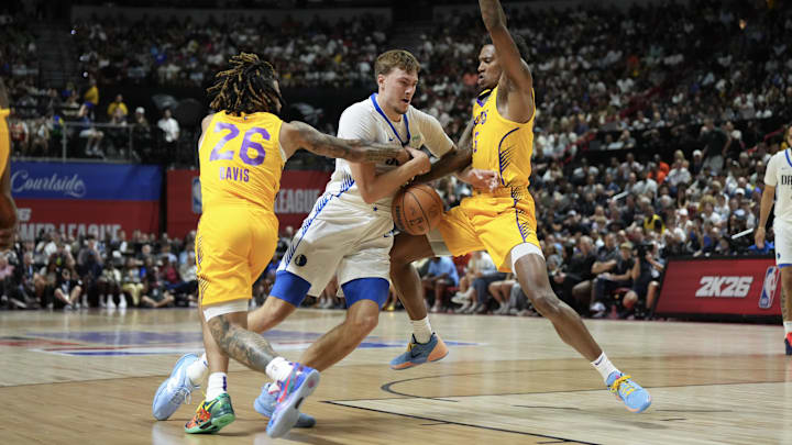 Jul 10, 2025; Las Vegas, NV, USA; Dallas Mavericks forward Cooper Flagg (32) dribbles against Los Angeles Lakers guard RJ Davis (26) and guard DaJaun Gordon (45) in the first quarter of their game at Thomas & Mack Center. Mandatory Credit: Candice Ward-Imagn Images Jul 10, 2025; Las Vegas, NV, USA; Dallas Mavericks forward Cooper Flagg (32) dribbles against Los Angeles Lakers guard RJ Davis (26) and guard DaJaun Gordon (45) in the first quarter of their game at Thomas & Mack Center. Mandatory Credit: Candice Ward-Imagn Images