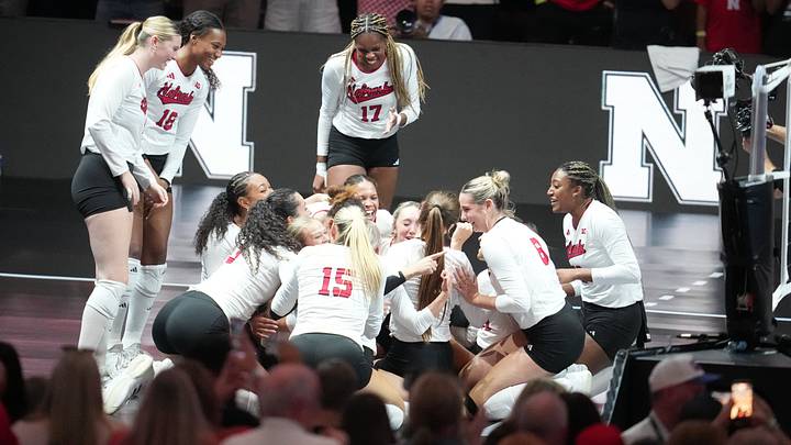  Nebraska Cornhuskers volleyball players celebrate after a win