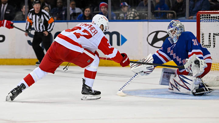 Oct 14, 2024; New York, New York, USA;  New York Rangers goaltender Igor Shesterkin (31) makes a glove save on Detroit Red Wings left wing J.T. Compher (37) during the second period at Madison Square Garden. Mandatory Credit: Dennis Schneidler-Imagn Images