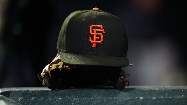 Sep 15, 2023; Denver, Colorado, USA; General view of a San Francisco Giants cap and glove during the ninth inning against the Colorado Rockies at Coors Field. 