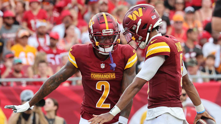 Sep 8, 2024; Tampa, Florida, USA;  Washington Commanders quarterback Jayden Daniels (5) celebrates with wide receiver Dyami Brown (2) after he scored a touchdown during the second half at Raymond James Stadium. Mandatory Credit: Kim Klement Neitzel-Imagn Images