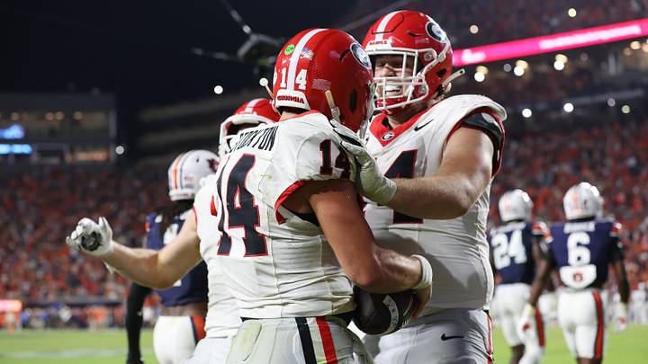 Oct 11, 2025; Auburn, Alabama, USA; Georgia Bulldogs quarterback Gunner Stockton (14) celebrates a touchdown with offensive lineman Drew Bobo (74) during the fourth quarter against the Auburn Tigers at Jordan-Hare Stadium. Mandatory Credit: John Reed-Imagn Images Oct 11, 2025; Auburn, Alabama, USA; Georgia Bulldogs quarterback Gunner Stockton (14) celebrates a touchdown with offensive lineman Drew Bobo (74) during the fourth quarter against the Auburn Tigers at Jordan-Hare Stadium. Mandatory Credit: John Reed-Imagn Images