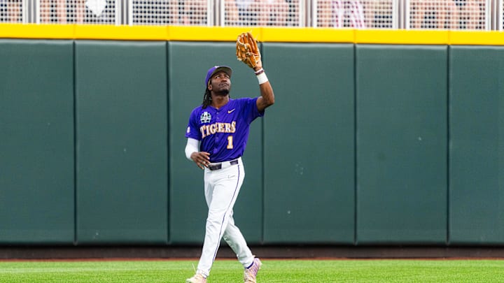 Jun 14, 2025; Omaha, Neb, USA; LSU Tigers center fielder Chris Stanfield (1) catches for an out against the Arkansas Razorbacks during the first inning at Charles Schwab Field. Mandatory Credit: Dylan Widger-Imagn Images