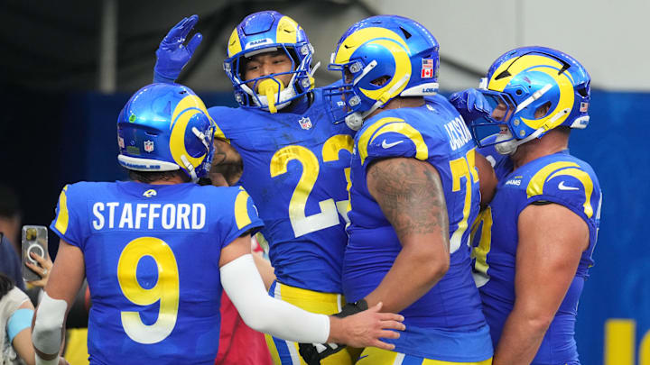 Dec 8, 2024; Inglewood, California, USA; Los Angeles Rams running back Kyren Williams (23) celebrates with quarterback Matthew Stafford (9) and offensive tackle Alaric Jackson (77) after scoring in a 7-yard touchdown run against the Buffalo Bills in the third quarter at SoFi Stadium. Mandatory Credit: Kirby Lee-Imagn Images