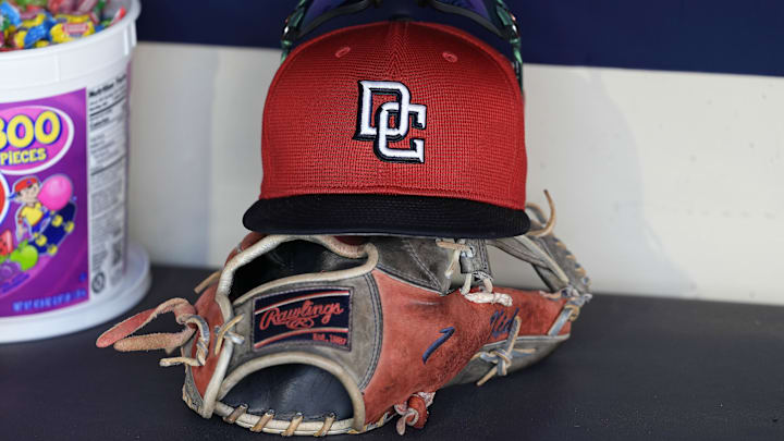 Jul 12, 2024; Milwaukee, Wisconsin, USA; An Washington Nationals hat and glove sit in the dugout during batting practice prior to the game against the Milwaukee Brewers at American Family Field. Jul 12, 2024; Milwaukee, Wisconsin, USA; An Washington Nationals hat and glove sit in the dugout during batting practice prior to the game against the Milwaukee Brewers at American Family Field.