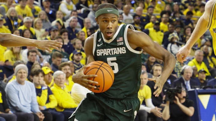 Feb 21, 2025; Ann Arbor, Michigan, USA; Michigan State Spartans guard Tre Holloman (5) handles the ball during the first half against the Michigan Wolverines at Crisler Center. Mandatory Credit: Brian Bradshaw Sevald-Imagn Images
