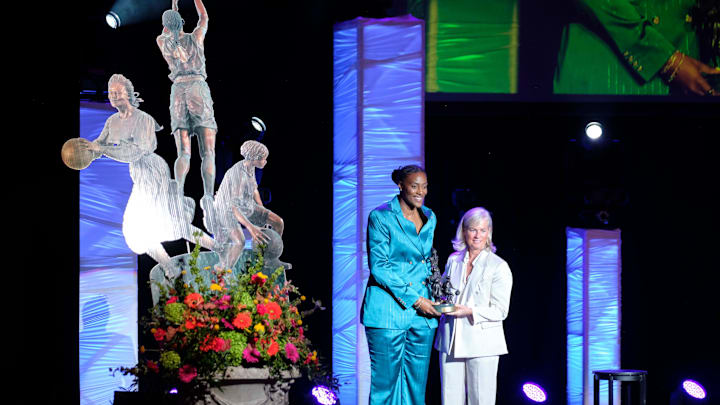 Women's Basketball Hall of Fame Inductee, Sylvia Fowles, receives the Berenson Trophy from Kristen Hughes, Smith College Athletic Director, during the 2025 Women’s Basketball Hall of Fame Induction Ceremony at the Tennessee Theatre, June 14, 2025, in Knoxville, Tenn. (Shawn Millsaps/Special to News Sentinel)