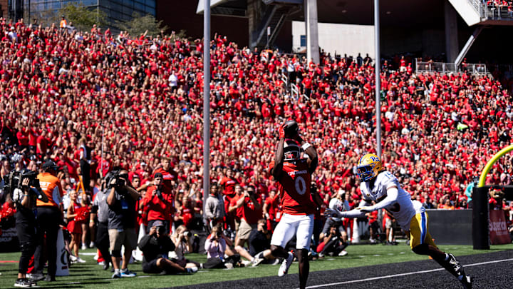 Cincinnati Bearcats wide receiver Tony Johnson (0) scores a touchdown as Pittsburgh Panthers defensive back Rashad Battle (15) in the first quarter of the College Football game at Nippert Stadium in Cincinnati on Saturday, Sept. 7, 2024.