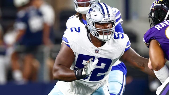 Dallas Cowboys guard Tyler Booker blocks during the first half against the Baltimore Ravens. Dallas Cowboys guard Tyler Booker blocks during the first half against the Baltimore Ravens.