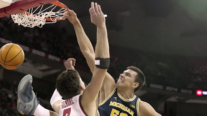 Dec 3, 2024; Madison, Wisconsin, USA; Michigan center Vladislav Goldin (50) dunks on Wisconsin forward Carter Gilmore (7) during the first half of their game Tuesday, December 3, 2024 at the Kohl Center in Madison, Wisconsin. Mandatory Credit: Mark Hoffman/USA TODAY Network via Imagn Images 