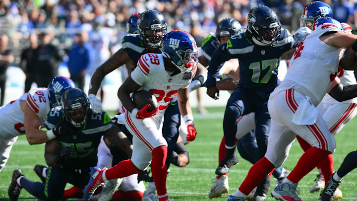 Oct 6, 2024; Seattle, Washington, USA; New York Giants running back Tyrone Tracy Jr. (29) carries the ball against the Seattle Seahawks during the first half at Lumen Field. Mandatory Credit: Steven Bisig-Imagn Images