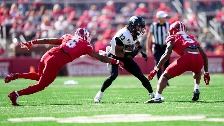 Oct 3, 2026; Madison, Wisconsin, USA;  Michigan State Spartans' Chrishon McCray (13) rushes with the football between Wisconsin Badgers cornerbacks Jai'mier Scott (6) and Bryce West (5) after catching a pass during the first quarter at Camp Randall Stadium. Mandatory Credit: Jeff Hanisch-Imagn Images