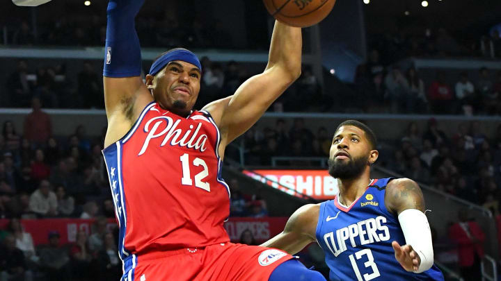 Mar 1, 2020; Los Angeles, California, USA;  Philadelphia 76ers forward Tobias Harris (12) gets past Los Angeles Clippers guard Paul George (13) for a dunk in the second half of the game at Staples Center.  Mandatory Credit: Jayne Kamin-Oncea-USA TODAY Sports