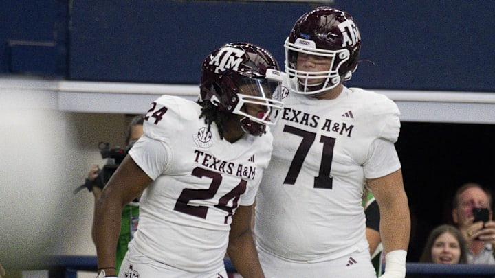 Sep 30, 2023; Arlington, Texas, USA; Texas A&M Aggies running back Earnest Crownover (24) and offensive lineman Chase Bisontis (71) celebrate after Crownover scores a touchdown against the Arkansas Razorbacks during the first half at AT&T Stadium. Mandatory Credit: Jerome Miron-Imagn Images