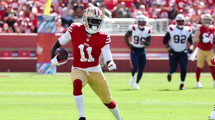 Sep 29, 2024; Santa Clara, California, USA; San Francisco 49ers wide receiver Brandon Aiyuk (11) runs with the ball past New England Patriots linebacker Jahlani Tavai (48) during the first quarter at Levi's Stadium. Mandatory Credit: Sergio Estrada-Imagn Images Sep 29, 2024; Santa Clara, California, USA; San Francisco 49ers wide receiver Brandon Aiyuk (11) runs with the ball past New England Patriots linebacker Jahlani Tavai (48) during the first quarter at Levi's Stadium. Mandatory Credit: Sergio Estrada-Imagn Images