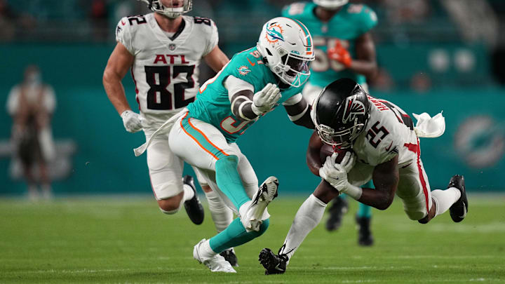 Aug 21, 2021; Miami Gardens, Florida, USA; Miami Dolphins defensive back Trill Williams (51) tackles Atlanta Falcons running back Javian Hawkins (25) during the second half at Hard Rock Stadium. Aug 21, 2021; Miami Gardens, Florida, USA; Miami Dolphins defensive back Trill Williams (51) tackles Atlanta Falcons running back Javian Hawkins (25) during the second half at Hard Rock Stadium.