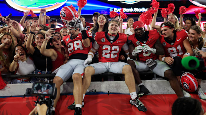 Georgia Bulldogs wide receiver Walter Blanchard (28), defensive back Jake Pope (22), Georgia Bulldogs running back Nate Frazier (3) and place kicker Peyton Woodring (91) celebrate after the game of an NCAA college football matchup Saturday, Nov. 2, 2024 at EverBank Stadium in Jacksonville, Fla. The Georgia Bulldogs defeated the Florida Gators 34-20. [Corey Perrine/Florida Times-Union]