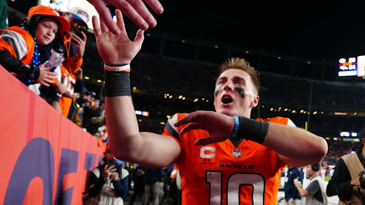 Dec 14, 2025; Denver, Colorado, USA; Denver Broncos quarterback Bo Nix (10) high-fives fans after defeating the Green Bay Packers at Empower Field at Mile High. Mandatory Credit: Ron Chenoy-Imagn Images