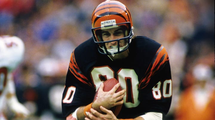 Nov 25, 1984; Cincinnati, OH, USA; FILE PHOTO; Cincinnati Bengals receiver Cris Collinsworth (80) carries the ball against the Atlanta Falcons at Riverfront Stadium. Mandatory Credit: Manny Rubio-Imagn Images