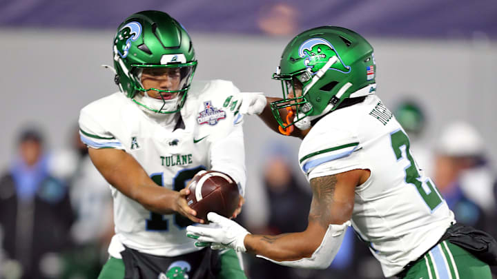 Dec 6, 2024; West Point, NY, USA; Tulane Green Wave quarterback Darian Mensah (10) hands off the ball to running back Shaadie Clayton-Johnson (2) during the first half against the Army Black Knights at Michie Stadium. 
