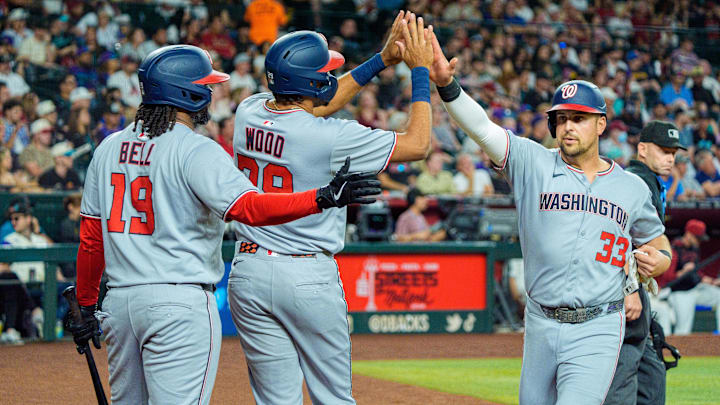 May 31, 2025; Phoenix, Arizona, USA;  Washington Nationals infielder Josh Bell (19) outfielder James Wood (29) and infielder Nathaniel Lowe (33) celebrate after Wood and Lowe score the second and third run of the first inning against the Arizona Diamondbacks at Chase Field.