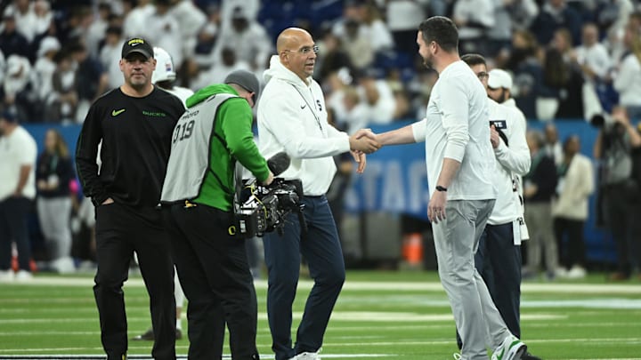 Penn State coach James Franklin shakes hands with Oregon Ducks coach Dan Lanning in the 2024 Big Ten Championship game at Lucas Oil Stadium. 