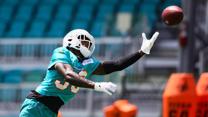 Miami Dolphins cornerback Siran Neal (33) reaches for the football during mandatory minicamp at Baptist Health Training Complex in the 2024 offseason.