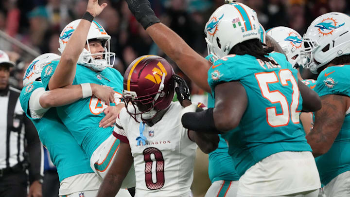 Miami Dolphins placekicker Riley Patterson (47) celebrates after scoring a field goal in overtime as Washington Commanders cornerback Mike Sainristil (0) reacts after the 2025 NFL Madrid Game at Santiago Bernabeu Stadium.