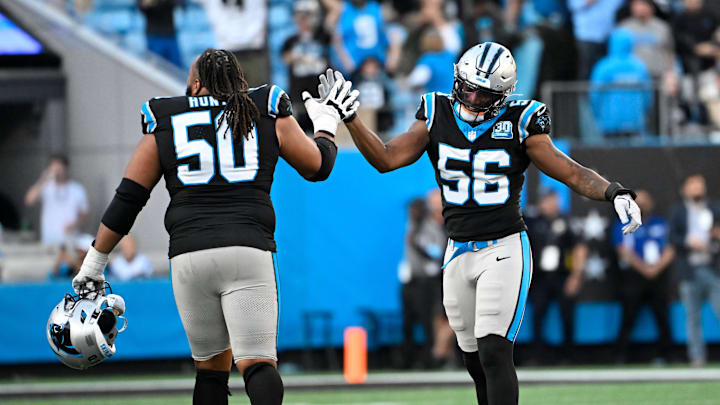 Nov 3, 2024; Charlotte, North Carolina, USA; Carolina Panthers linebacker Trevin Wallace (56) reacts with guard Robert Hunt (50) in the fourth quarter at Bank of America Stadium. Mandatory Credit: Bob Donnan-Imagn Images