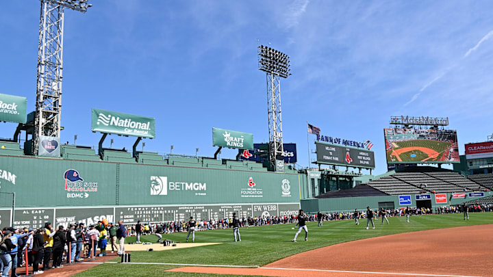 Apr 20, 2025; Boston, Massachusetts, USA; Fans line the field in front of the Green Monster as the Chicago White Sox warm up before a game at Fenway Park. Mandatory Credit: Eric Canha-Imagn Images