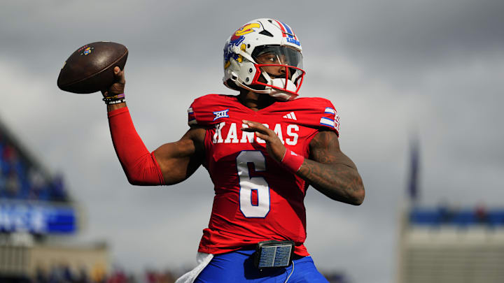Nov 1, 2025; Lawrence, Kansas, USA; Kansas Jayhawks quarterback Jalon Daniels (6) warms up during the first half against the Oklahoma State Cowboys at David Booth Kansas Memorial Stadium. Mandatory Credit: Jay Biggerstaff-Imagn Images Nov 1, 2025; Lawrence, Kansas, USA; Kansas Jayhawks quarterback Jalon Daniels (6) warms up during the first half against the Oklahoma State Cowboys at David Booth Kansas Memorial Stadium. Mandatory Credit: Jay Biggerstaff-Imagn Images
