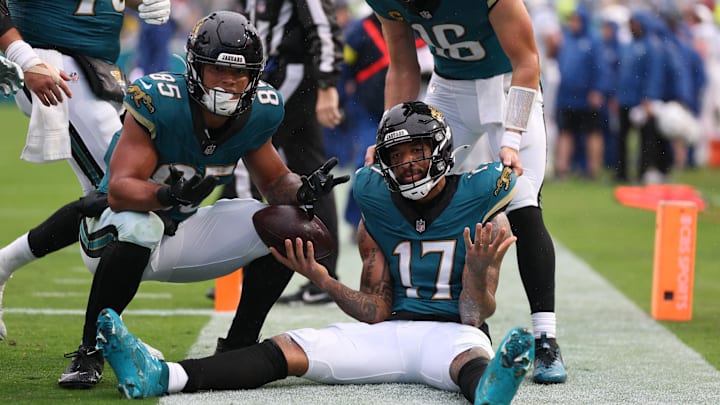 Dec 7, 2025; Jacksonville, Florida, USA; Jacksonville Jaguars wide receiver Tim Patrick (17) sits on the field after catching a touchdown pass, as teammates tight end Brenton Strange (85) and quarterback Trevor Lawrence (16) join in against the Indianapolis Colts during the first half at EverBank Stadium. Mandatory Credit: Matt Pendleton-Imagn Images Dec 7, 2025; Jacksonville, Florida, USA; Jacksonville Jaguars wide receiver Tim Patrick (17) sits on the field after catching a touchdown pass, as teammates tight end Brenton Strange (85) and quarterback Trevor Lawrence (16) join in against the Indianapolis Colts during the first half at EverBank Stadium. Mandatory Credit: Matt Pendleton-Imagn Images