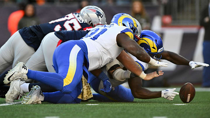 Nov 17, 2024; Foxborough, Massachusetts, USA; Los Angeles Rams linebacker Byron Young (0) reaches to recover a fumble against the New England Patriots during the first half at Gillette Stadium. Mandatory Credit: Brian Fluharty-Imagn Images Nov 17, 2024; Foxborough, Massachusetts, USA; Los Angeles Rams linebacker Byron Young (0) reaches to recover a fumble against the New England Patriots during the first half at Gillette Stadium. Mandatory Credit: Brian Fluharty-Imagn Images