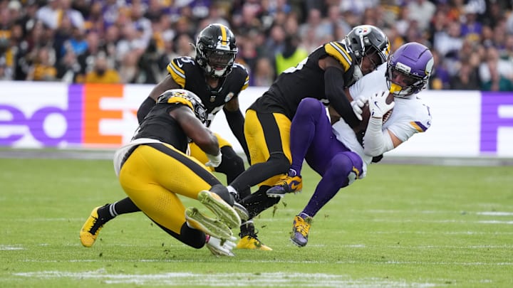 Sep 28, 2025; Dublin, Ireland; Minnesota Vikings wide receiver Adam Thielen (19) is tackled by Pittsburgh Steelers cornerback Brandin Echols (26) and linebacker Patrick Queen (6) during the second quarter during an NFL International Series game at Croke Park.