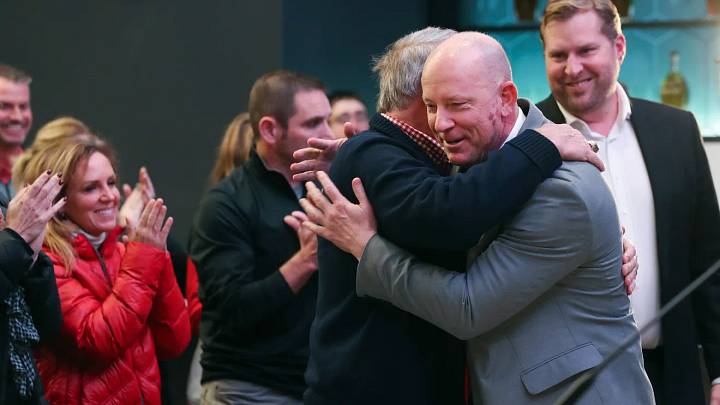 Louisville football coach Jeff Brohm embraces Dennis Lampley after Brohm was introduced as the Cardinals' head coach. Louisville football coach Jeff Brohm embraces Dennis Lampley after Brohm was introduced as the Cardinals' head coach.