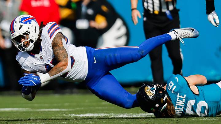 Jacksonville Jaguars quarterback Trevor Lawrence (16) tackles Buffalo Bills linebacker Shaq Thompson (45) after throwing an interception Jacksonville Jaguars quarterback Trevor Lawrence (16) tackles Buffalo Bills linebacker Shaq Thompson (45) after throwing an interception