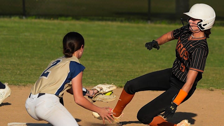 Sandalwood Saints Madison Seprish (2) outs Tocoi Creek Toros Ryleigh Williams (9) in the top of the second inning at Sandalwood High School in Jacksonville, Fla. Wednesday April 22, 2026. Tocoi Creek defeated Sandlewood 10-1.