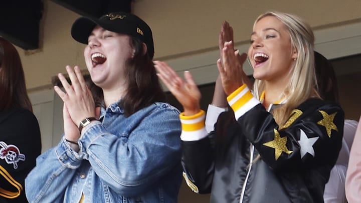 May 11, 2024; Pittsburgh, Pennsylvania, USA;  Louisiana State University gymnast Olivia Dunn (right) cheers as her boyfriend Pittsburgh Pirates starting pitcher Paul Skenes (not pictured) records a strikeout in his major league debut against the Chicago Cubs during the fourth inning at PNC Park. Mandatory Credit: Charles LeClaire-Imagn Images