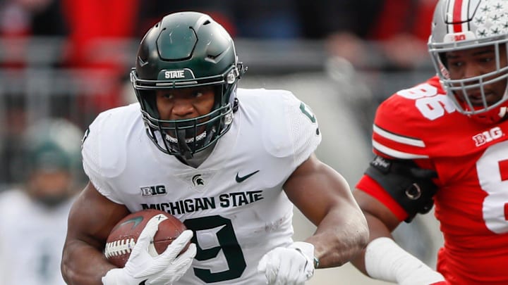 Michigan State running back Kenneth Walker III runs past Ohio State Buckeyes defensive tackle Jerron Cage during the first quarter at Ohio Stadium in Columbus, Ohio on Nov. 20, 2021.

Syndication The Providence Journal
