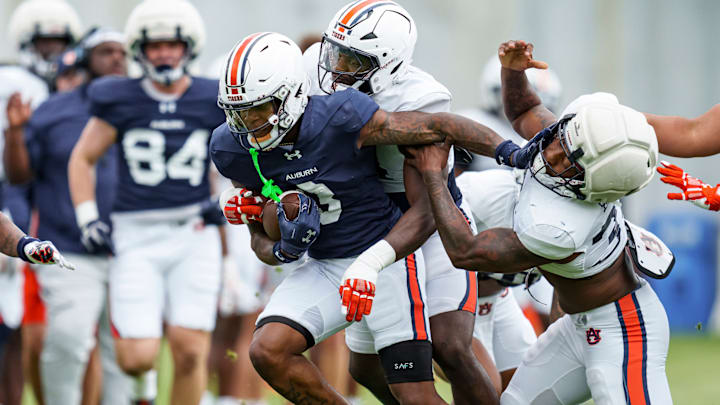 Auburn Wide Receiver Perry Thompson fights off linebackers Keyron Crawford and DJ Barber during spring practice. 