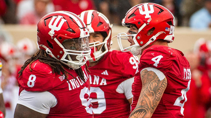 Indiana's Aiden Fisher (4) and CJ West (8) celebrate a sack against Maryland at Memorial Stadium. Indiana's Aiden Fisher (4) and CJ West (8) celebrate a sack against Maryland at Memorial Stadium.