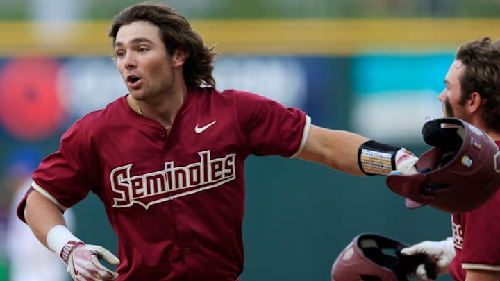 Florida State infielder Drew Faurot (3) celebrates scoring during the fourth inning of an NCAA