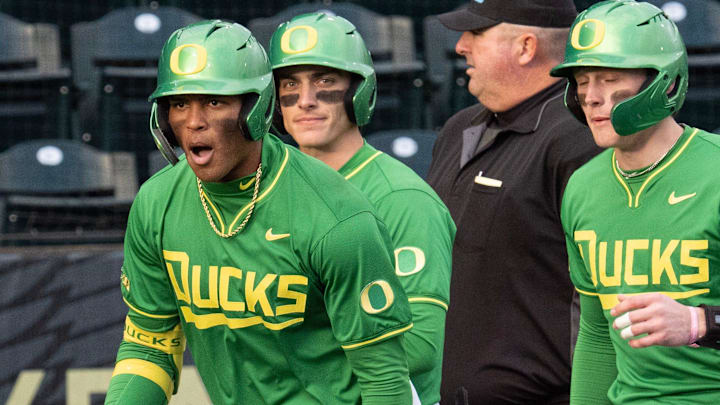 Oregon’s Jacob Walsh, left, celebrates an RBI homer against Toledo at PK Park in Eugene Friday, Feb. 14, 2025.